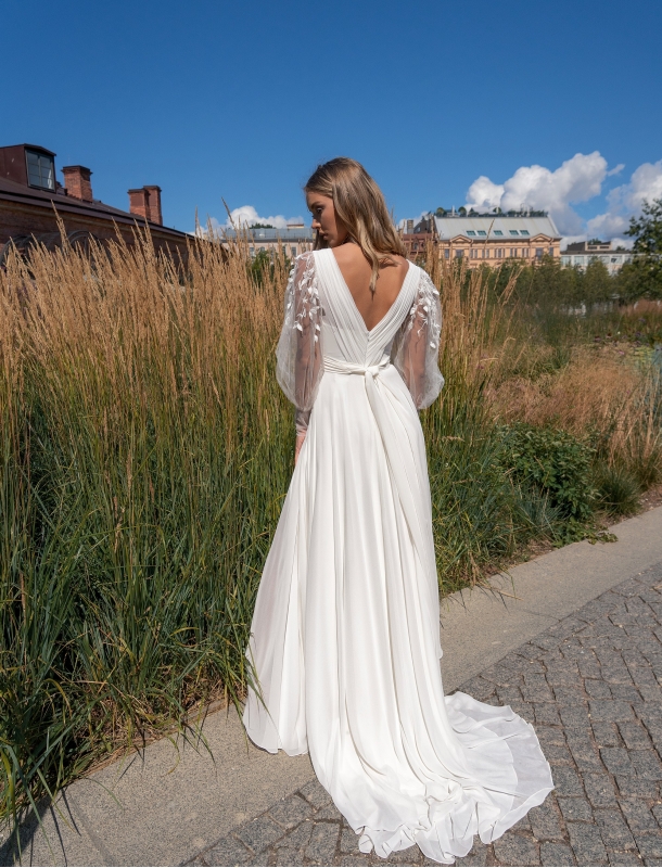 Wedding dress with a transparent sleeves and a cut